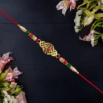 Shop Now Gold Finish Ganesha Rakhi – Spiritual Rakhi for Bhai