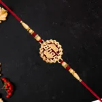 Traditional Swastik Rakhi – Gold Plated with Red Thread & Beads