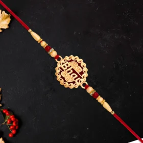 Traditional Swastik Rakhi – Gold Plated with Red Thread & Beads