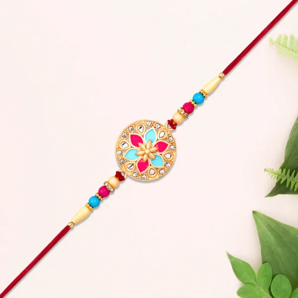 Handcrafted Floral Rakhi – Round Dial with Pink-Blue Enamel & Beads
