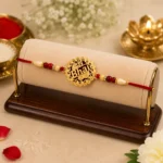 Golden Swastik Rakhi with Red Beads and Thread