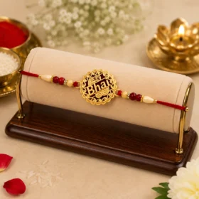 Golden Swastik Rakhi with Red Beads and Thread