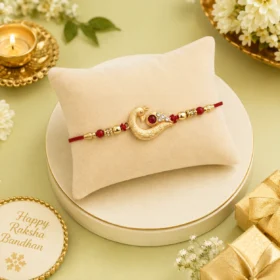 Golden Peacock Feather Rakhi with Red Thread and Kundan Detailing
