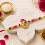 Stylish Ganesh Design Rakhi with Multicolor Beads and Gold Finish Accents